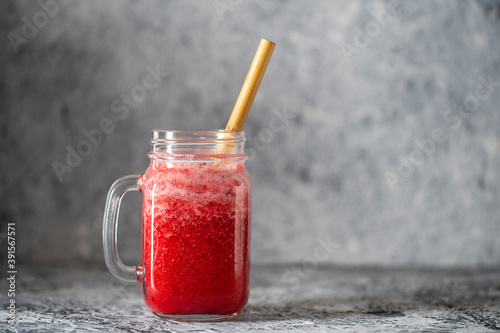 Cranberry and cowberry smoothie in mason jar with bamboo straw. Refreshing summer fruit drink. The concept of healthy eating. Copy space