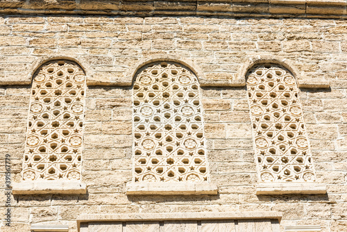 Patterned stone windows of medieval building in Baku, Azerbaijan photo