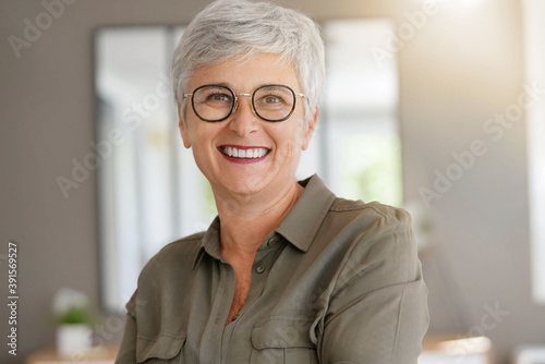 Portrait of a cheerful 55-year-old woman with white hair