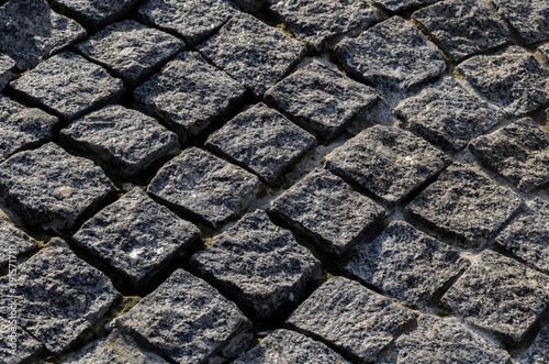 Fragment of stone pavement-granite paving