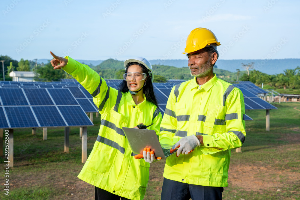 Engineer and Technician checking equipment in solar panels for great efficiency. Engineer and Technician checking equipment in solar panels for great efficiency.