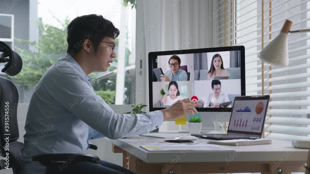 Business man talking about sale report in video conference.Asian team using laptop and tablet online meeting in video call.Working from home, Working remotely and Self isolation at home