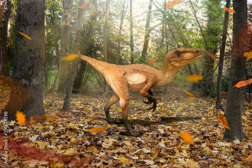 Velociraptor walks in the autumn forest with falling leaves in the Jurassic period. Moment of peace and tranquility. © fabio