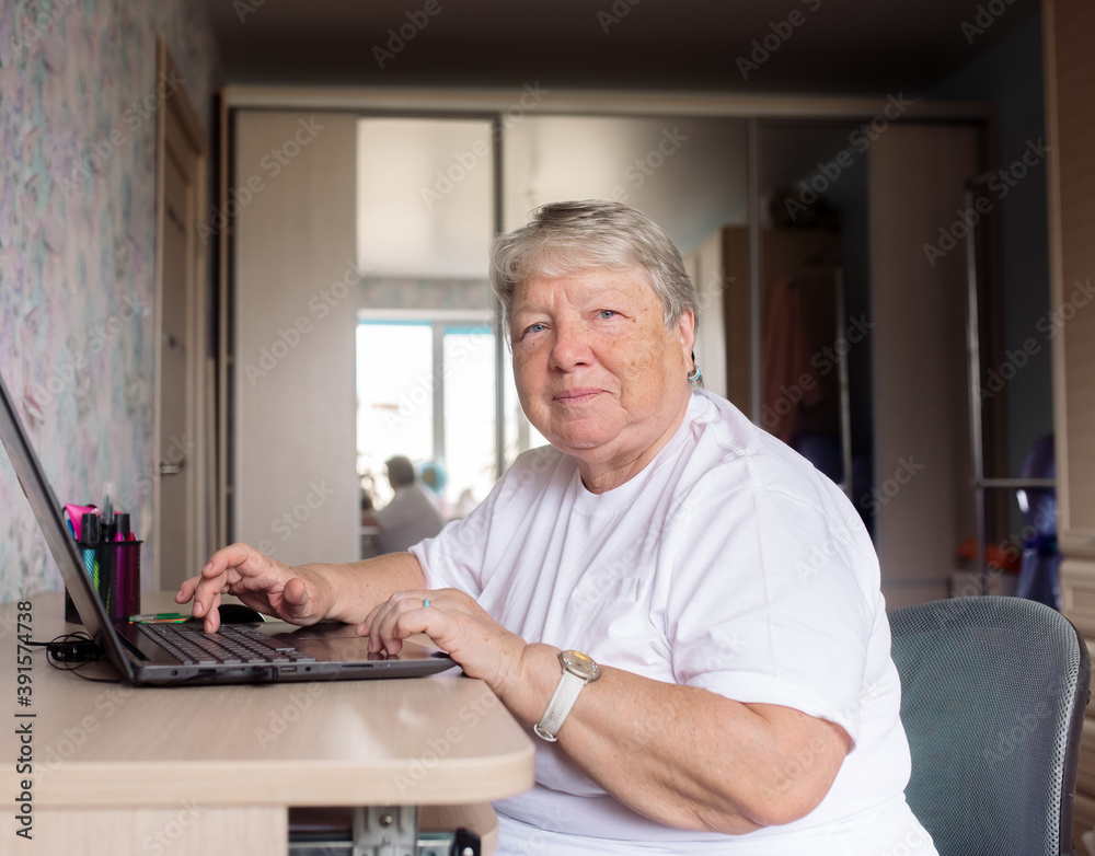 senior woman learning to work on a computer while sitting at a laptop at home
senior woman learning to work on a computer while sitting at a laptop at home