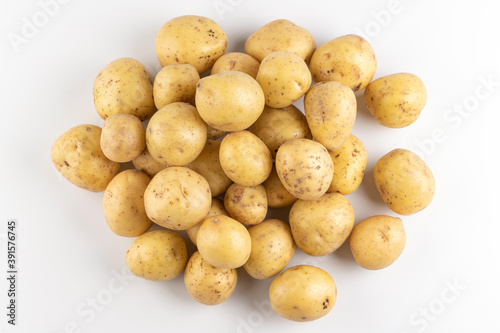 New raw potatoes isolated on white background close up, top view, flat lay