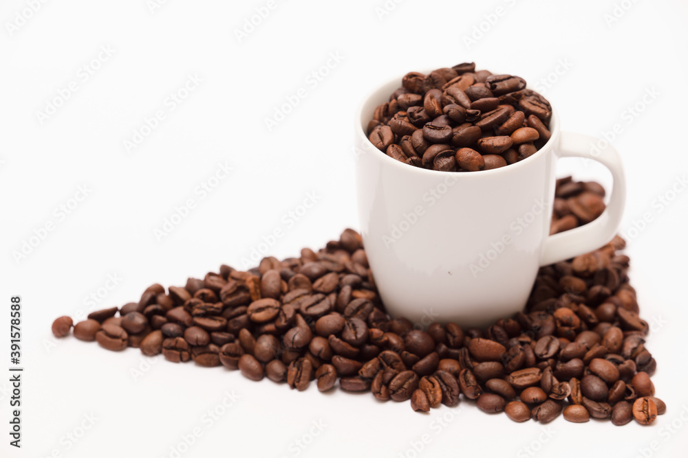 white ceramic cup, with coffee beans and white background