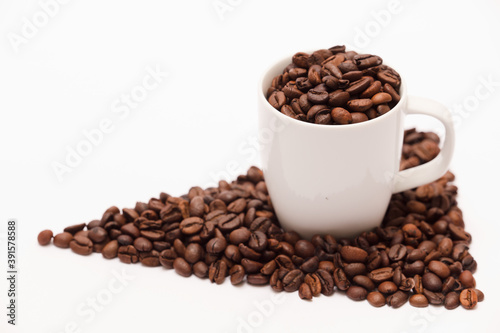 white ceramic cup, with coffee beans and white background