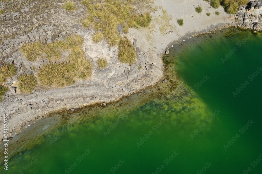 Aerial view over a lake with chemical dark green water
