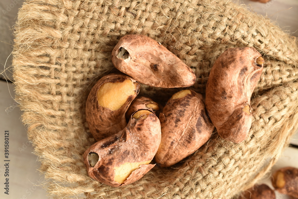 Fragrant fried salted cashews on a jute fabric, close-up. Fragrant fried salted cashews on a jute fabric, close-up.