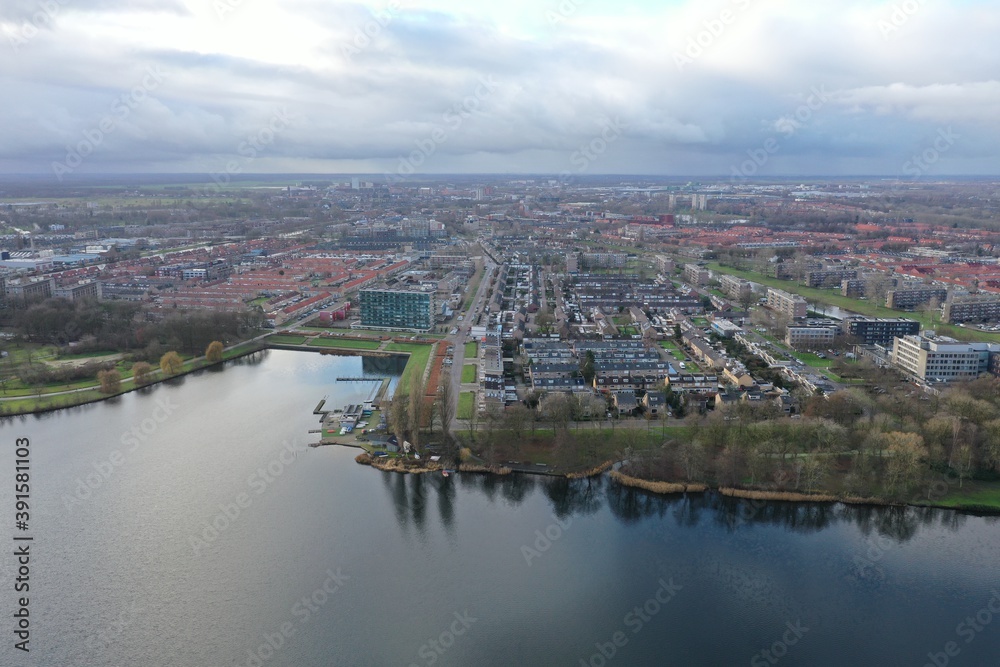 Aerial view over a small lake found in a large city in Europe