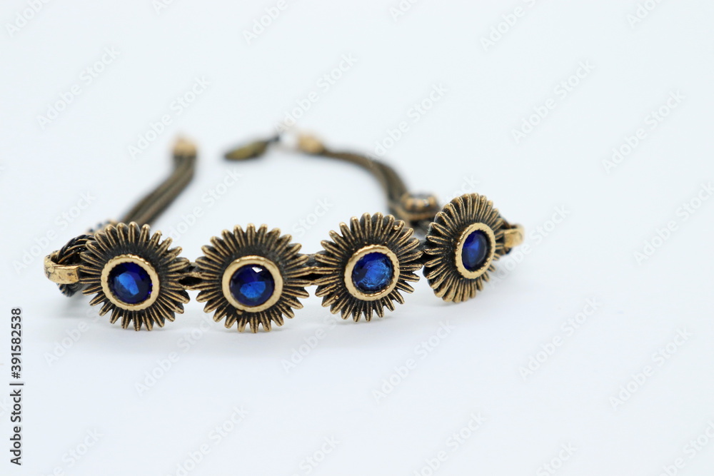 bronze bracelet with blue crystals, white background
bronze bracelet with blue crystals, white background