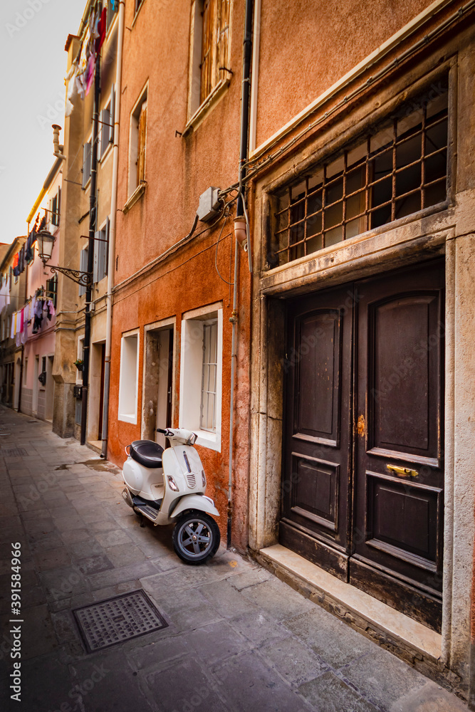 8 november 2020 Chioggia Venice Italy - Scooter in typical narrow italian street
