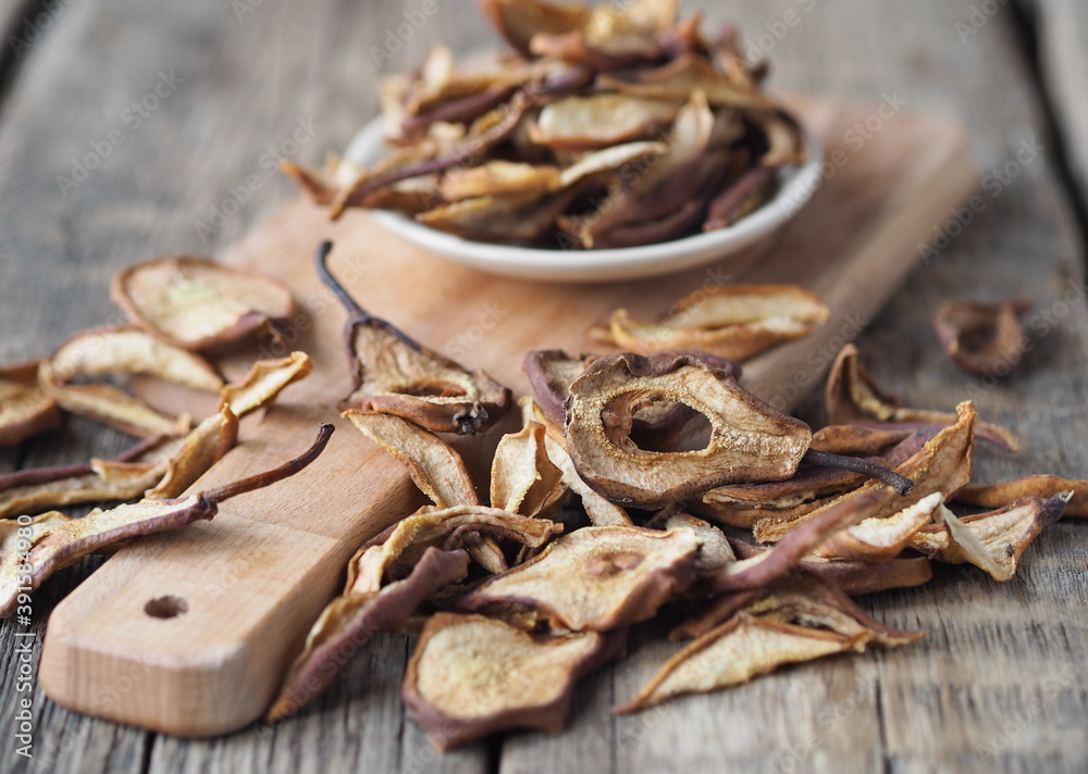 Dried pear on a wooden ancient background. Home harvesting dried fruits.