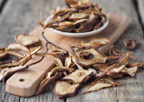 Dried pear on a wooden ancient background. Home harvesting dried fruits.