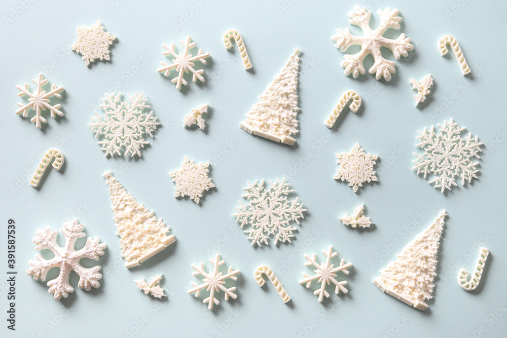 Christmas pattern of white holiday DIY decoration on blue. Xmas abstract background. Christmas pattern of white holiday DIY decoration on blue. Xmas abstract background.