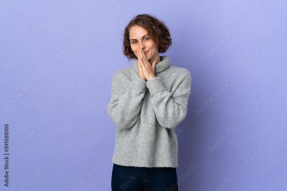 Young English woman isolated on purple background keeps palm together. Person asks for something Young English woman isolated on purple background keeps palm together. Person asks for something