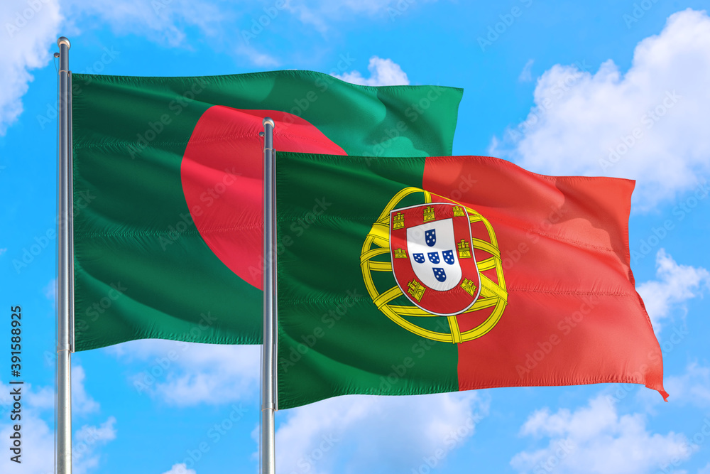 Portugal and Bangladesh national flag waving in the windy deep blue sky. Diplomacy and international relations concept. Portugal and Bangladesh national flag waving in the windy deep blue sky. Diplomacy and international relations concept.
