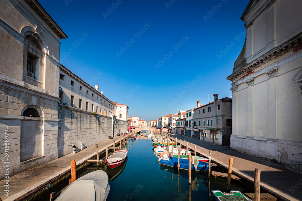 Naklejka premium Romantic cityscape of Ghioggia - near Venice - with canals, buidings, bridges and canals in Daylight. Bridge Filippini