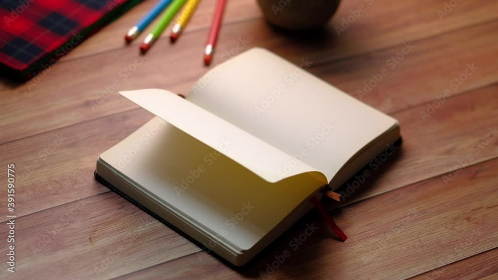 open book and a pencil on wooden table open book and a pencil on wooden table