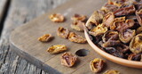 Home preparation of dried fruits. Wooden background with dried apricots.
