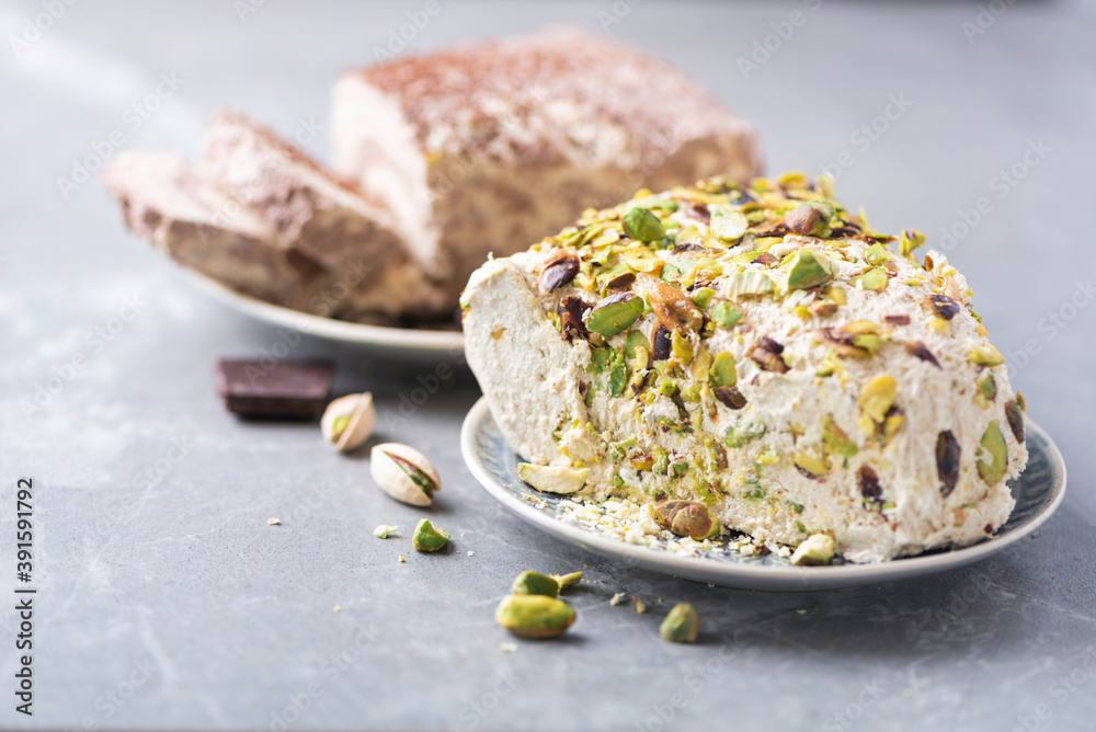 Sesame chocolate halva and halva with pistachios on grey background ...
