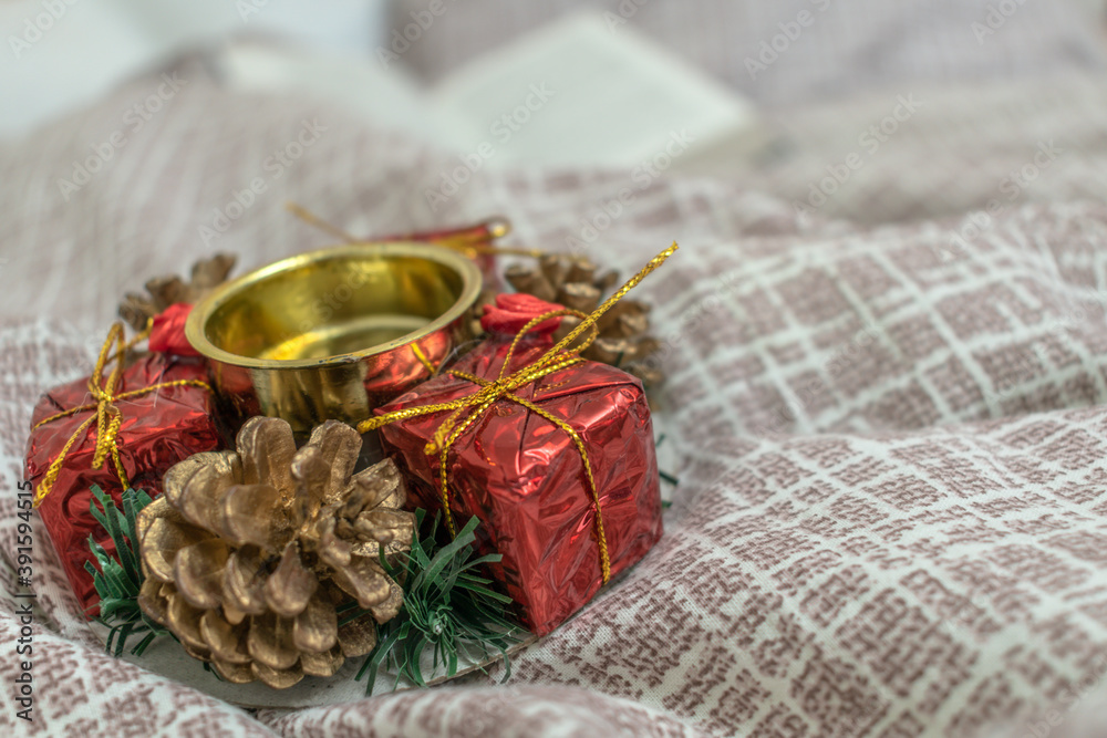 Gift with a pine cone on a candlestick. Christmas background.