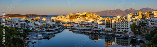Fototapeta Naklejka Na Ścianę i Meble -  Beautiful late even sunlight illuminating buildings in the centre of the Cretan town of Agios Nikolaos