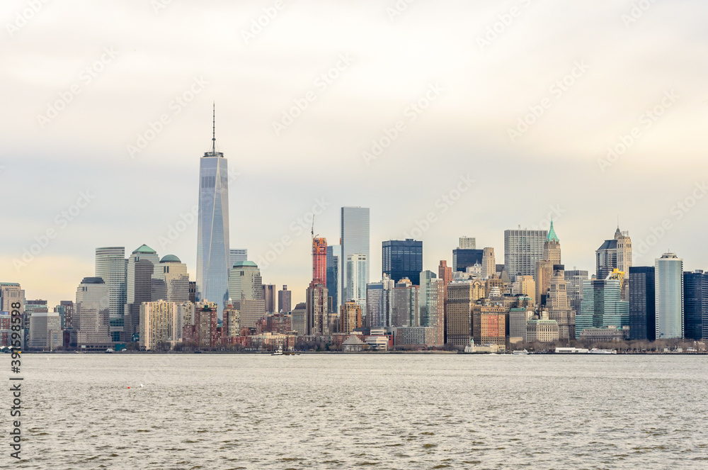 Obraz premium Manhattan Cityscape. Futuristic Buildings, Skyscrapers and Towers. The Largest Metropolitan Area in the World. Shot Taken from Ellis Island. New York City, USA