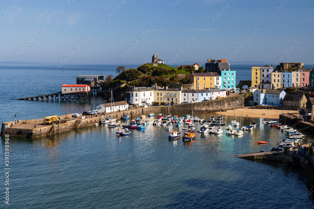 People around the harbour enjoying late summer sunshine in the picturesque Welsh seaside town of Tenby in Pembrokeshire