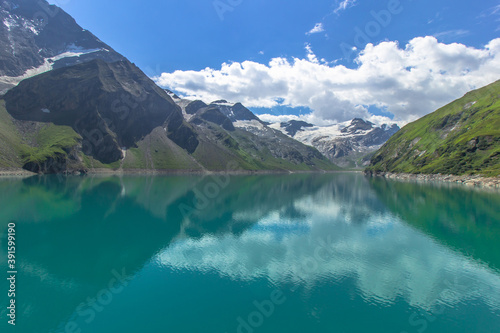 Beautiful view of high mountain lake near Kaprun.Hike to the Mooserboden dam in Austrian Alps.Quiet relaxation in nature.Wonderful nature landscape,turquoise tranquil lake,holiday travel scene.