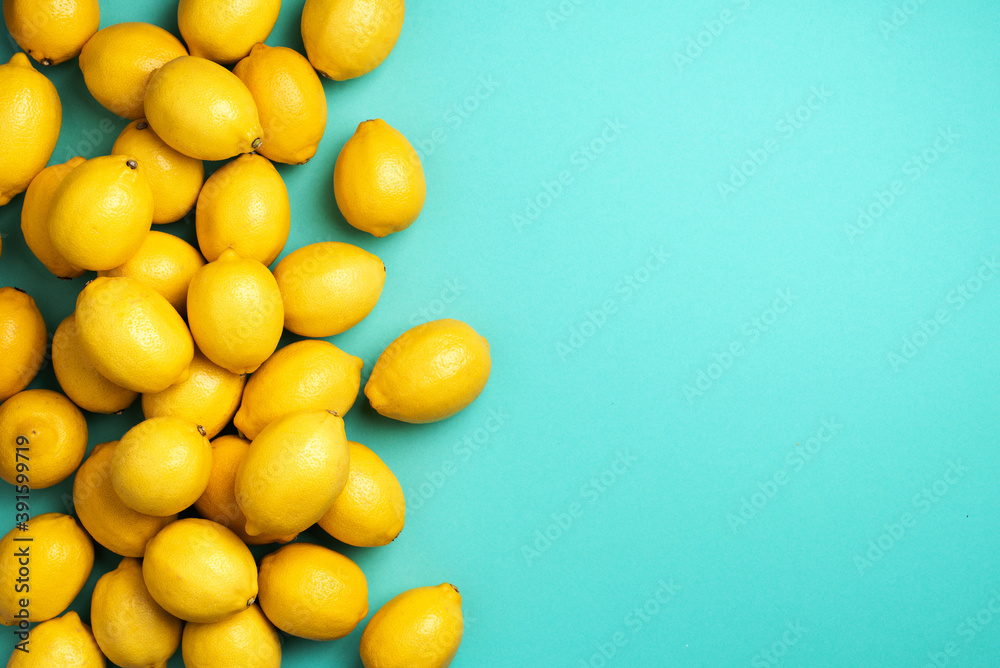 Lemons frame on blue background. Immune system booster. Copy space. Top view. Flat lay. Citrus fruits. Vitamins for health. Liposomal vitamin C. Lemon for vegan, vegetarian alkaline diet Lemons frame on blue background. Immune system booster. Copy space. Top view. Flat lay. Citrus fruits. Vitamins for health. Liposomal vitamin C. Lemon for vegan, vegetarian alkaline diet