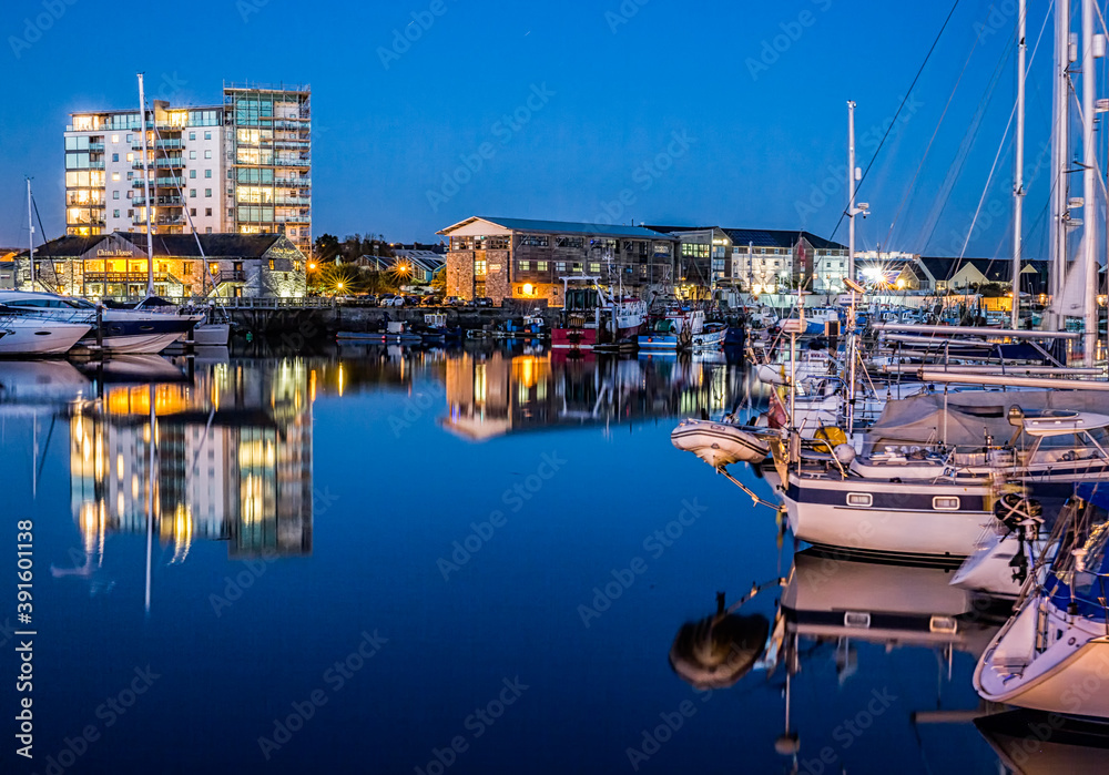 Yachts moored at the Plymouth Barbican Harbour at night