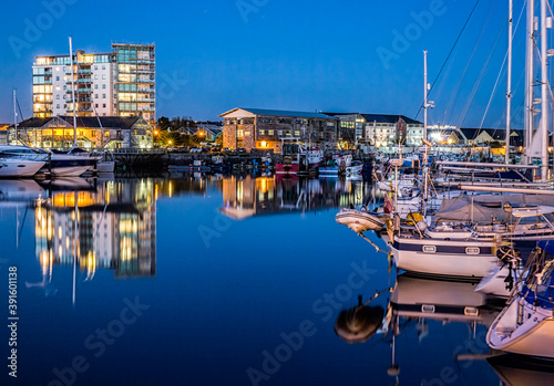 Yachts moored at the Plymouth Barbican Harbour at night photo