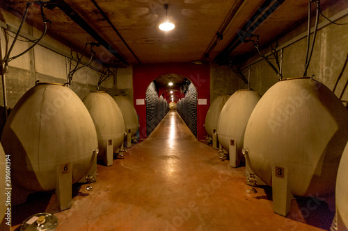 Corridor with wine storage tanks and piled up bottles in bodega in Santa Maria del Cami, Mallorca, Spain photo