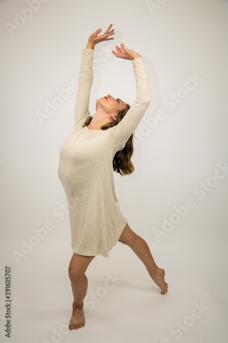 Fototapeta Naklejka Na Ścianę i Meble -  choreographed dancing beautiful girl white background contemp