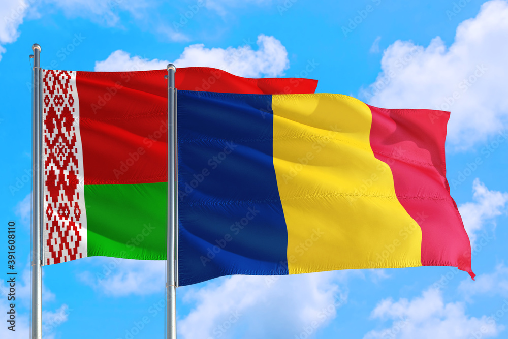 Romania and Belarus national flag waving in the windy deep blue sky. Diplomacy and international relations concept. Romania and Belarus national flag waving in the windy deep blue sky. Diplomacy and international relations concept.