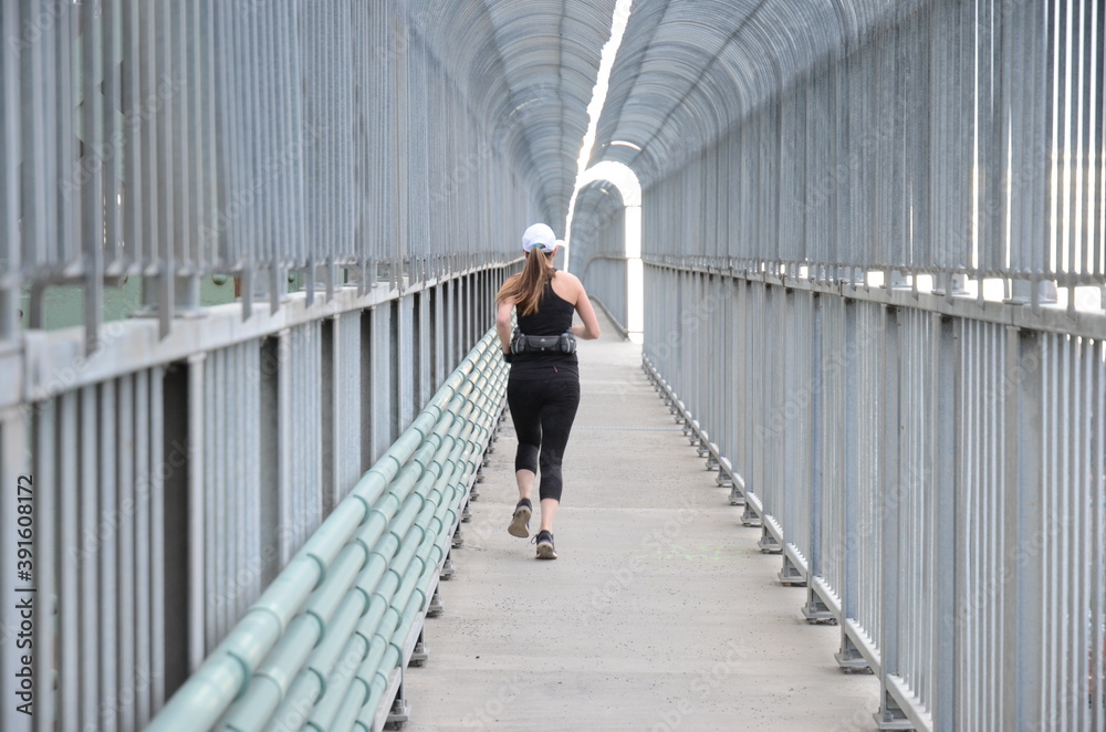 Jogging woman. Runner on Jacques Cartier Bridge