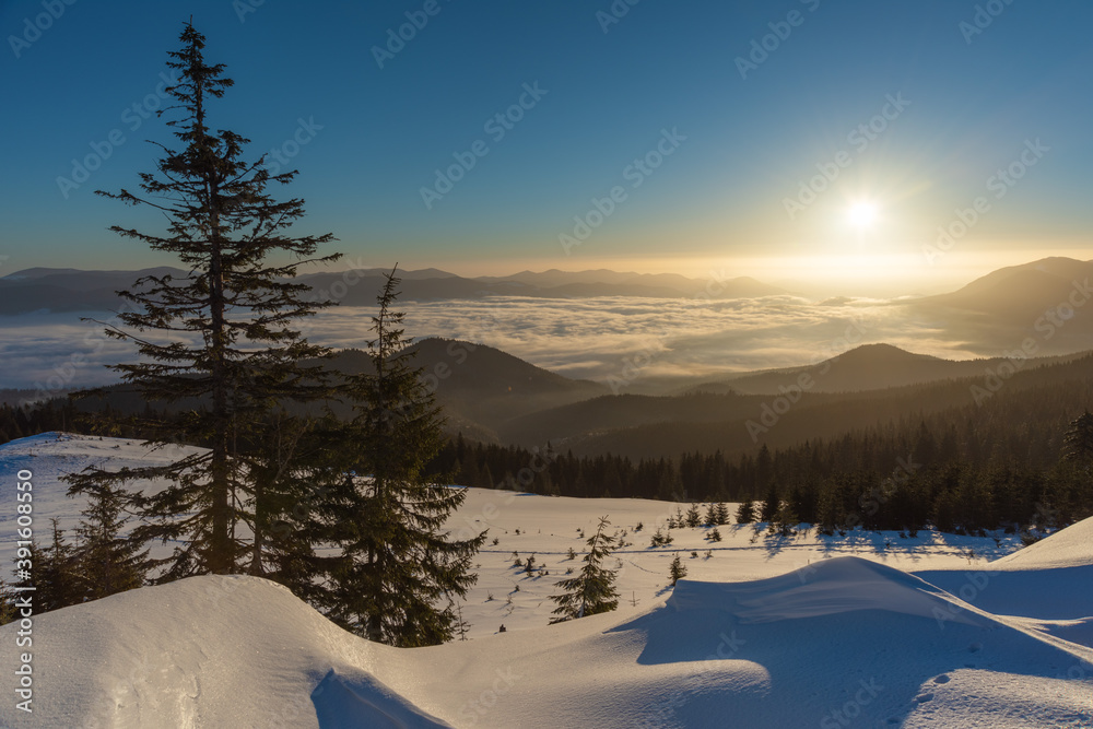 Winter in the Ukrainian Carpathian mountains with morning fogs