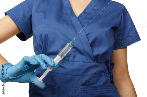 Woman doctor in blue gloves and a surgical gown holds a syringe with a drug in her hands in front of her chest. Health concept. Anesthesia or addiction from virus and disease Health care in hospital.
