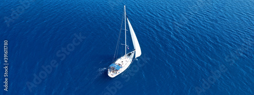 Aerial drone ultra wide panoramic photo of beautiful sailboat cruising the Aegean deep blue sea