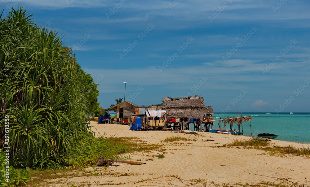 East Malaysia. Sea Gypsy village on a sandy coral reef island. The main trade of local residents is fishing and sea Souvenirs