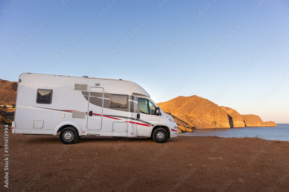 Spain; Nov 2020: Holidays season, caravan parked in front of the sea at sunset time. Vacations by the beach in Cabo de Gata, Almería, Andalusia, South of Spain