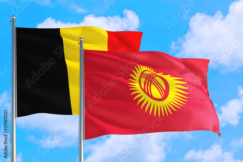 Kyrgyzstan and Belgium national flag waving in the windy deep blue sky. Diplomacy and international relations concept.