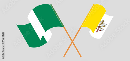 Crossed and waving flags of Vatican and Nigeria