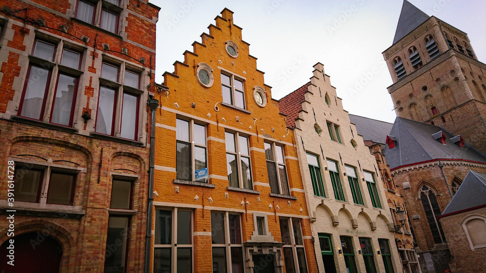 Bruges, Belgium - May 12, 2018: Roofs And Windows Of Old Authentic Brick Houses On Street Sint-Jakobsstraat Bruges, Belgium - May 12, 2018: Roofs And Windows Of Old Authentic Brick Houses On Street Sint-Jakobsstraat