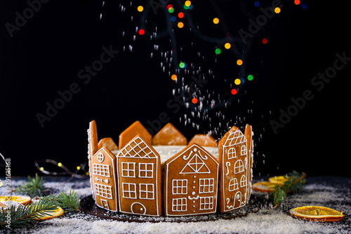 Beautiful delicious cake with sprigs of rosemary and orange frips. New Year's dessert. Biscuit cakes, gingerbread. photo