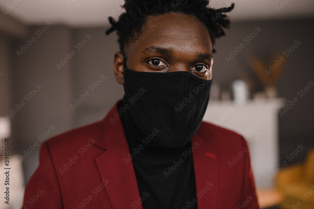 portrait of an afro american in a suit wears a black medical mask portrait of an afro american in a suit wears a black medical mask