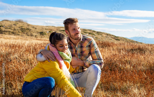 Young couple enjoying in the mountains fields.
