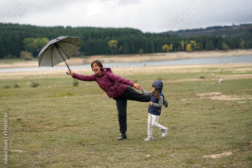 A little girl plays with her mother near Lake Cecita, in the Sila National Park in Italy photo