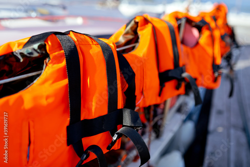 a few bright orange life jackets on the yacht fence 
